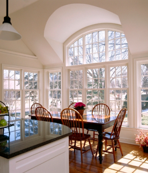 a kitchen with large picturesque windows during winter